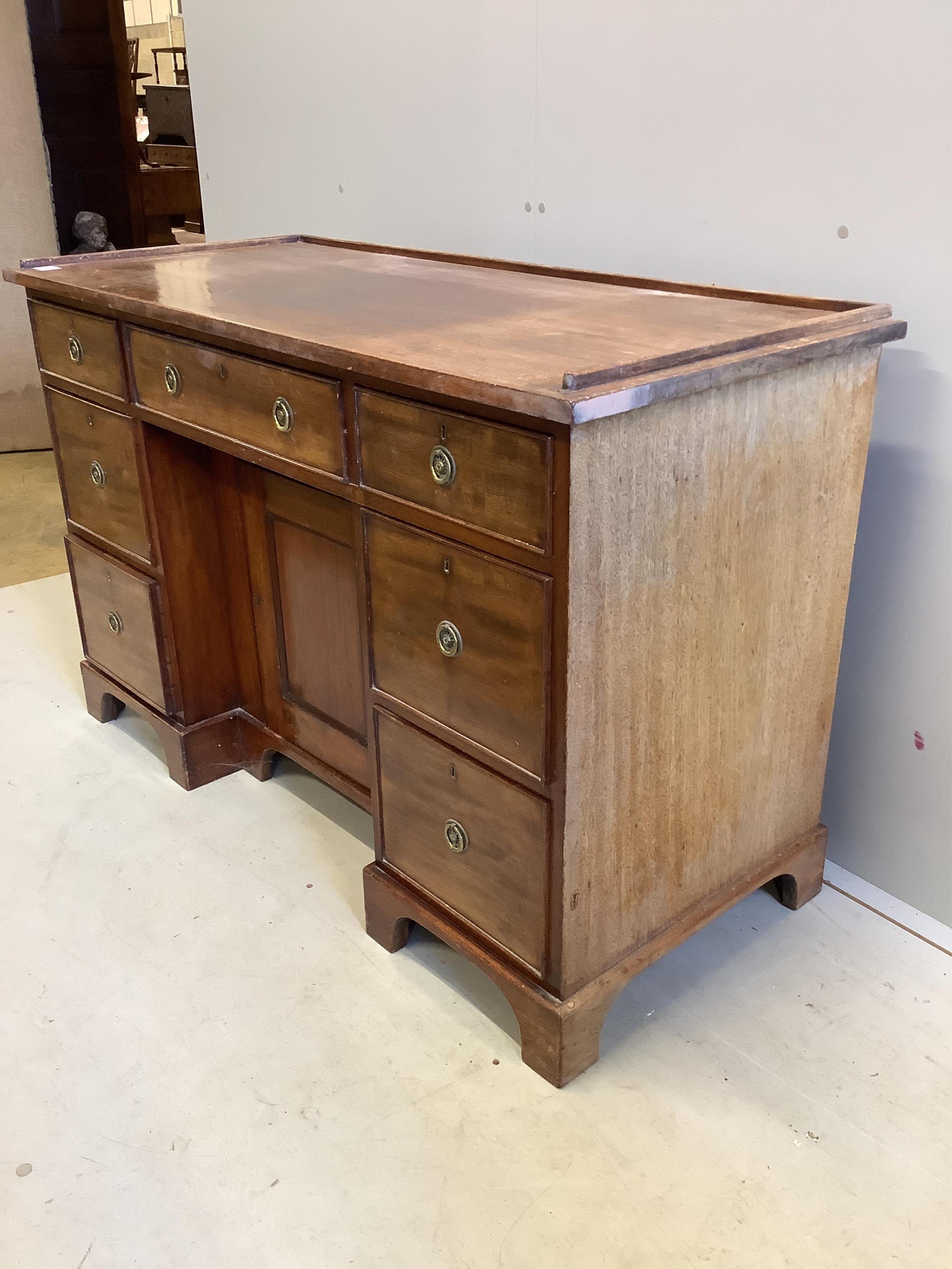 A Regency mahogany galleried topped dressing chest, fitted seven drawers, about a kneehole cupboard, width 127cm, depth 55cm, height 83cm. Condition - fair